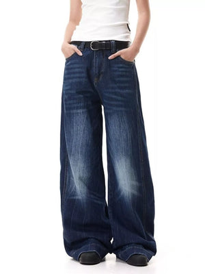 Belted wide leg jeans in washed blue denim with a relaxed fit.