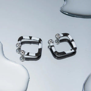 Geometric zebra stripe ear cuffs with silver ball details