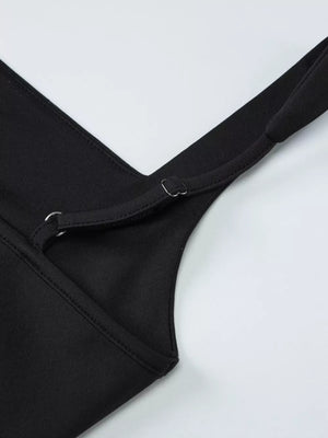 Black maxi dress detail showing adjustable spaghetti straps and neckline seam