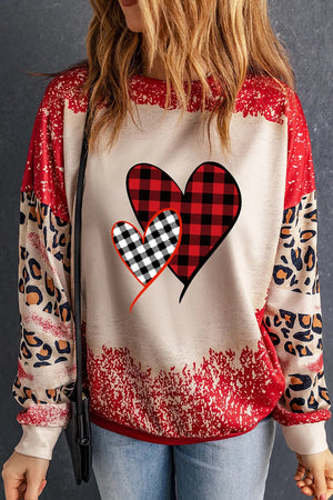 Plaid heart graphic sweatshirt in deep red with leopard print sleeves and distressed hem.