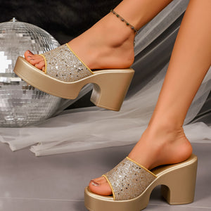 Gold glitter open-toe block heel sandals with a platform sole.