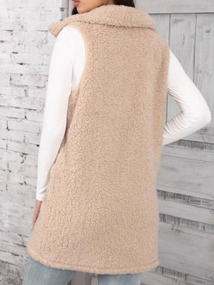 Tan sherpa utility vest with collar, button front, and full length.