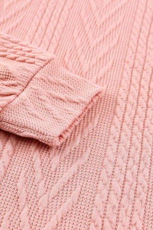 Pale blush knit sweater with chevron and textured sleeve details.