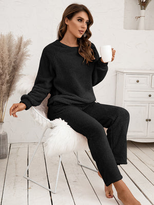 Black plush loungewear set with raglan sleeves and relaxed fit pants.