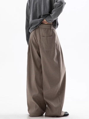 Men's wide leg check trousers in beige and brown with a relaxed fit.