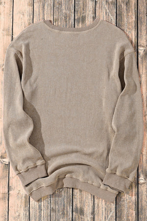Khaki textured ribbed crewneck pullover sweater with long sleeves and crew neckline.