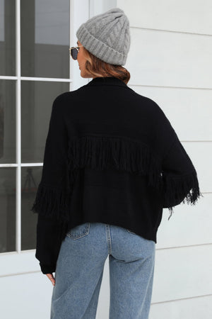Black acrylic cardigan with fringe detail on sleeves and back, relaxed fit.