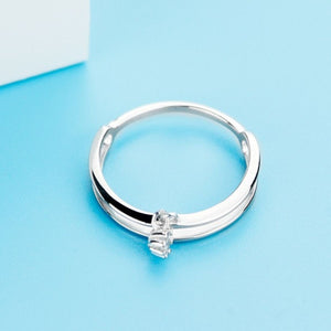 Elegant double layered sterling silver ring with a small charm accent.