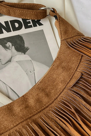 Brown suede crescent crossbody bag with fringe detail and silver hardware