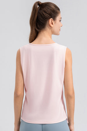 Blush pink active tank top with notched neckline and sleeveless design.