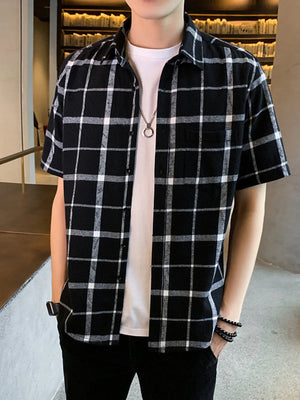 Men's black and white plaid short sleeve button-down shirt with chest pocket.