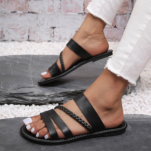 Black braided strap open-toe flat sandals with multiple leather straps.