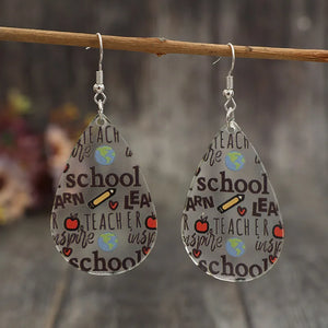 Schoolhouse graphic teardrop acrylic earrings with teacher, school, and apple designs.