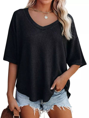 Black waffle knit relaxed v-neck t-shirt with short sleeves and a loose fit.