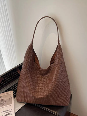 Brown woven straw texture tote bag with a single strap and open top.