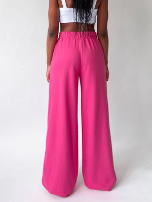 Hot pink wide-leg lounge pants with elastic waistband and full length.