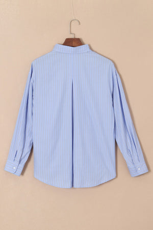Oversized light blue stripe oxford shirt with buttoned cuffs and back pleat detail.