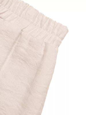 Boyshorts in apricot with elastic waist and textured fabric detail.
