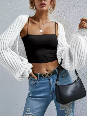 White balloon sleeve cropped knit cardigan with ribbed texture and open front.