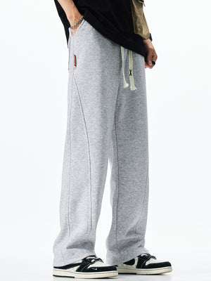 Men's grey casual drawstring sweatpants with loose fit and contrast stitching.