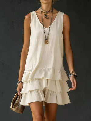 Tiered ruffled hem v-neck dress in white with a casual, airy style.