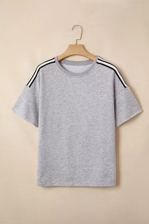 Grey relaxed t-shirt with black and white shoulder stripes, short sleeves, and crew neck.