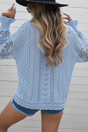Light blue openwork knit sweater with lace sleeves and diamond pattern detail