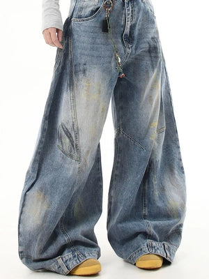 Washed blue wide-leg jeans with pocket detail and distressed accents.