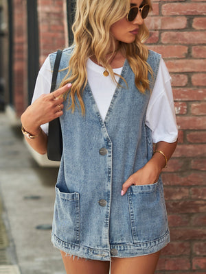 Oversized denim vest in medium wash with button front and two patch pockets.