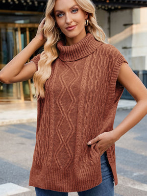 Cable knit turtleneck vest in caramel acrylic with side slits, styled casually.