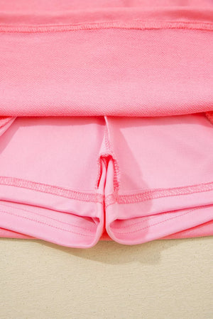 Dusty pink skort with visible stitching details and pocket lining.