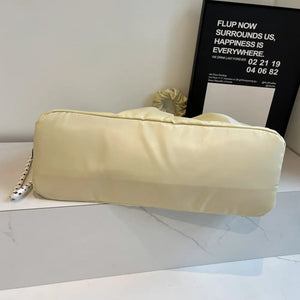 Ivory ruched handle crescent shoulder bag with black and white strap detail
