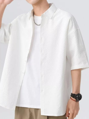 White textured short-sleeve men's shirt with button-up front and collar.