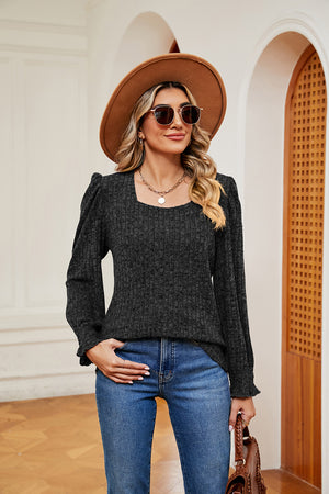 Textured dark gray knit blouse with square neckline and cuffed puff sleeves.