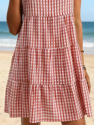 Red and white gingham tiered mini dress with a ruffled hem.