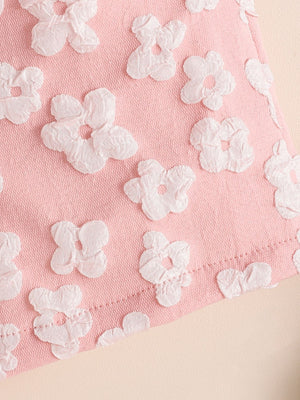 Pink cotton blend baby girls' bikini with allover white floral texture.