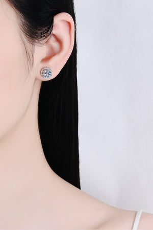 Sterling silver rope-framed moissanite stud earrings with a round cut center stone.