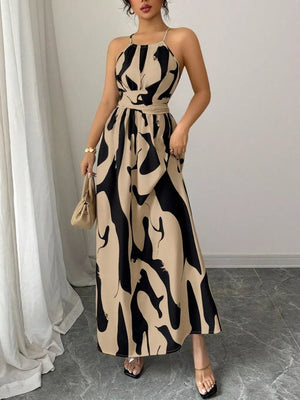 Chic halter neck maxi dress with abstract print in beige and black, belted waist, ankle length.