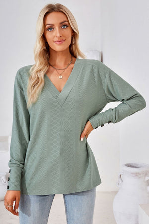 Sage green textured V-neck blouse with button cuff long sleeves.