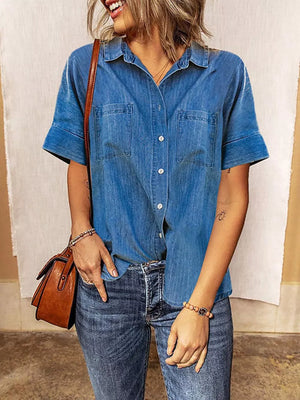 Dark blue denim button-front shirt with short sleeves and two chest pockets.