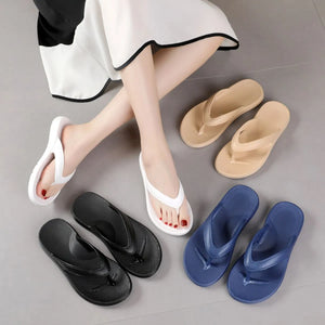 Textured rubber thong sandals in black, white, navy, and apricot colors.