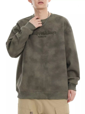 Oversized Army Green tie-dye sweatshirt with "Perfection Is Beauty IMPROVE" graphic.