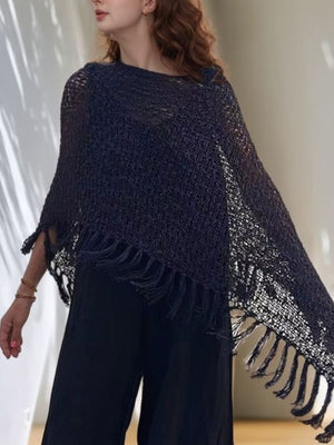 Open-knit boat neck poncho in black with fringe trim, acrylic material.
