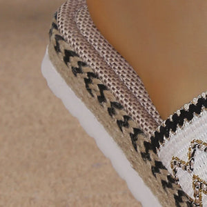 Embroidered espadrille platform slides with woven details and a white sole.