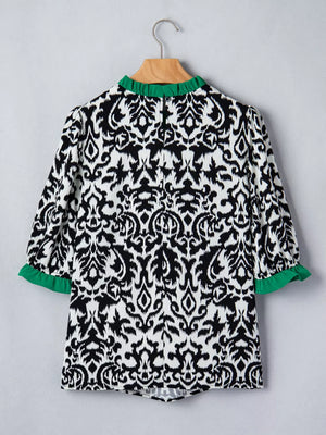 Damask print maternity blouse with green ruffled collar and cuffs, half sleeves.