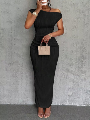 Black textured one-shoulder maxi dress with ruched detail and asymmetrical neckline.