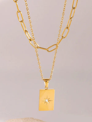 Gold celestial pendant layered chain necklace with starburst detail