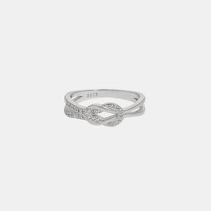 Silver knot ring with zirconia accents on a sterling silver band.