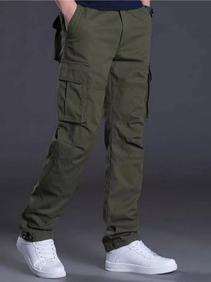 Men's green relaxed fit cargo pants with multiple pockets and cuffed ankles.