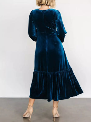 Peacock blue velvet midi dress with tiered skirt and long sleeves.